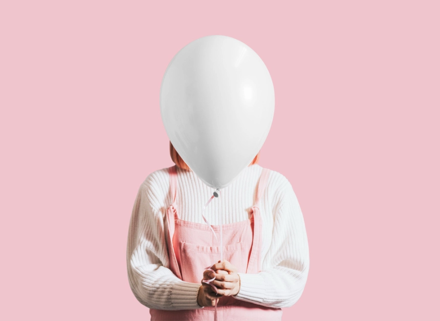 женщина держит в руках надутый воздушный шар